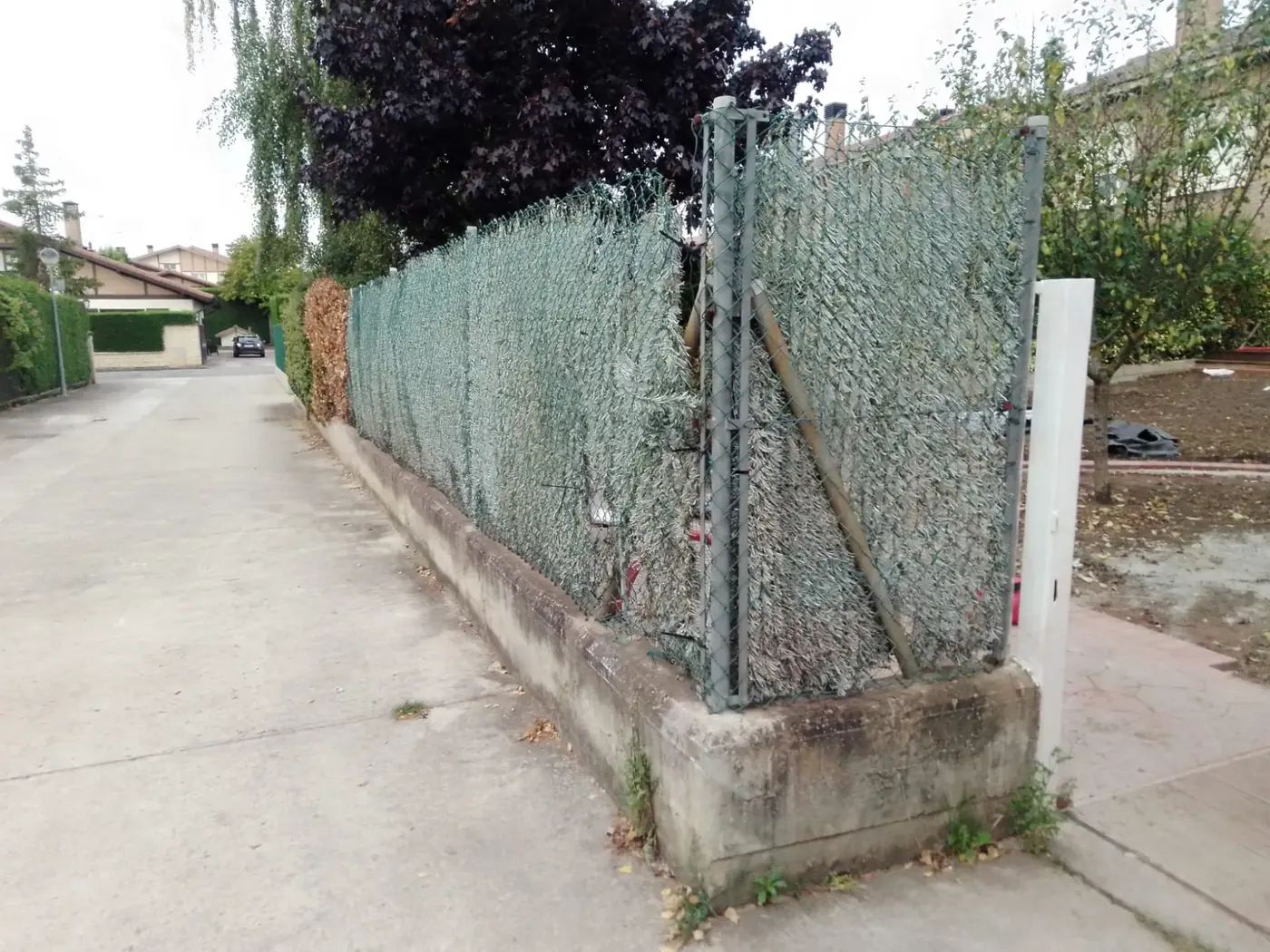 Valla de simple torsión antigua con seto artificial desgastado